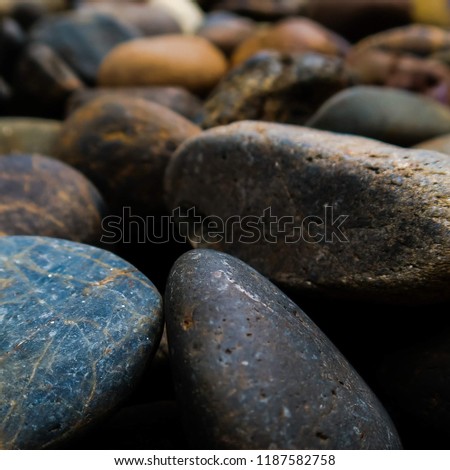 Close-up Natural abstract vintage colorful pebbles background. Blurred background of nature pebbles rock stone texture with Copy space for text. Wallpaper, backdrop and background of Nature tone.  Royalty-Free Stock Photo #1187582758