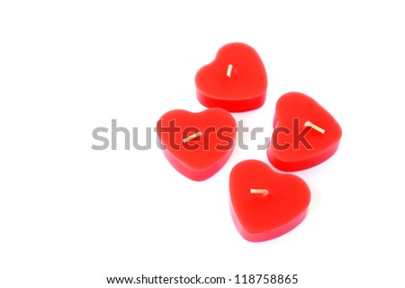Heart shape red candles isolated on white background.