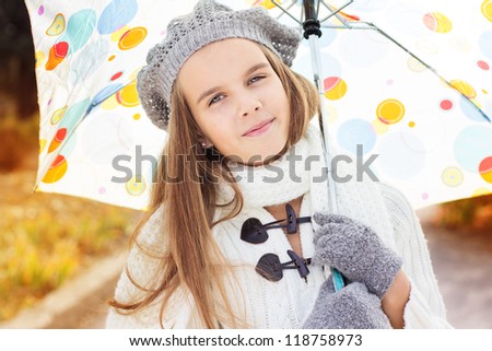 Beautiful little girl with colorful umbrella