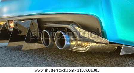 Blue car with dual exhaust pipe and tail spikes