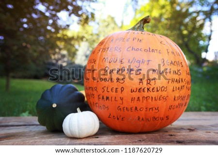 Image of a Thankful or Gratitude Pumpkin holiday craft tradition, thankful words written on a pumpkin