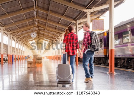 Young traveling backpacker on vacation at the train station, travel concept
