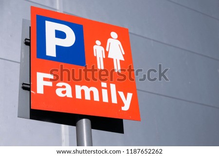 Family parents with kids children car park sign at shopping mall retail park