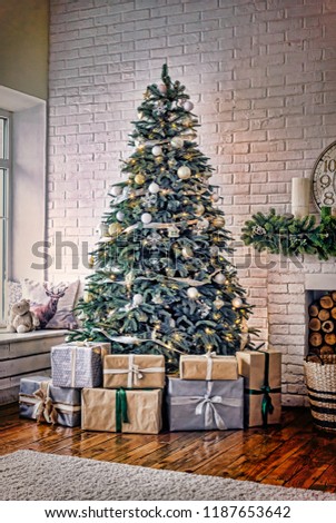 New Year decorated Christmas tree in a cozy home interior near the fireplace with a clock