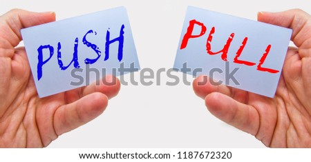 business man hands handling cards with push pull words 