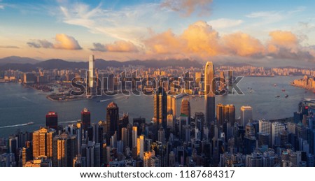 Hong Kong Downtown and Victoria Harbour. Financial district in smart city. Skyscraper and high-rise buildings. Aerial view at sunset.
