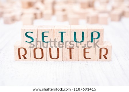The Words Setup Router Formed By Wooden Blocks On A White Table