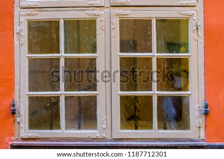 Rustic vintage window on red wall 