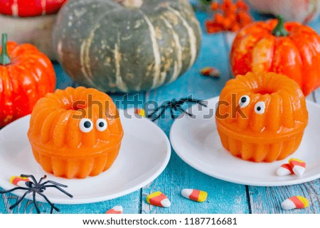 Halloween pumpkin jelly with candy eyes, fun and healthy dessert idea for kids