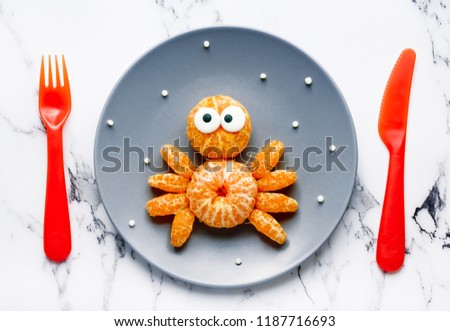Fruit spider snack for kids made from fresh tangerine