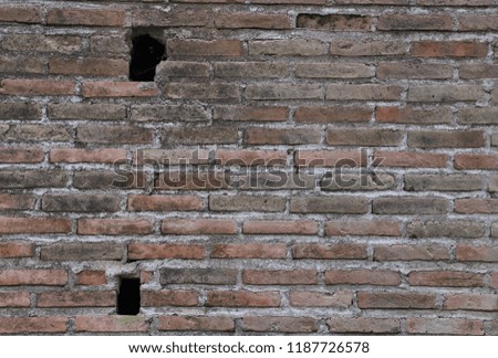 Closeup of vintage brick wall of old tobacco plant in sunny day. The natural art background and template.