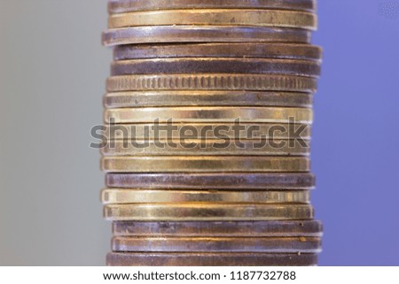 Vertical column of yellow old coins.