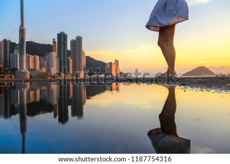 half a Lady and reflection at Sunset at Water front at Western District Public Cargo Working Area, Kennedy town, Victoria Harbour, Hong Kong 