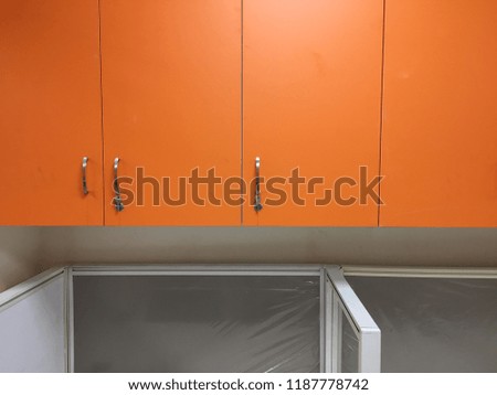 Interior of an office space, work space, desktop, cupboards and chairs