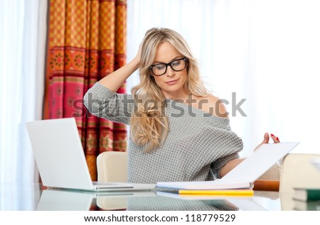 attractive woman writer in her home with laptop thinking expression