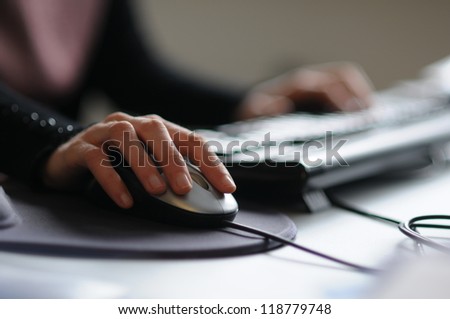Picture of female hand on computer mouse