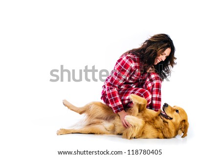 Beautiful woman wearing red flannel pajamas with her handsome golden retriever dog. Royalty-Free Stock Photo #118780405