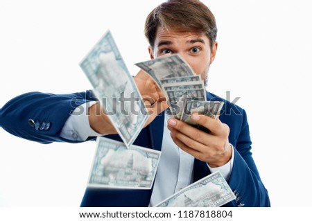 a man in a suit is scattered with money                               