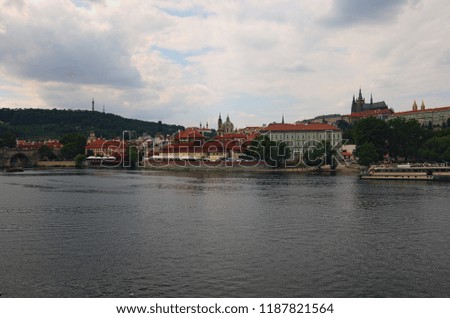 Panoramic view of historical center of Prague and Vltava river, Saint Vitus Cathedral at cloudy summer day. Buildings, cathedrals and landmarks of old town, Prague, Czech Republic.