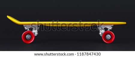 Yellow cruiser penny plastboard with red wheels isolated on black background, front view