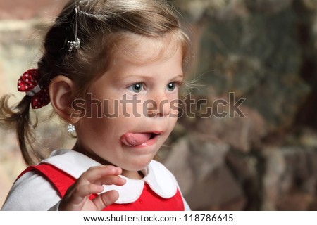 little beautiful girl with tongue