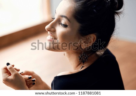 smiling woman near the window                           