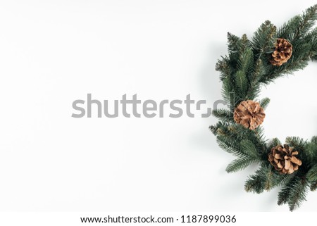 close-up view of beautiful christmas wreath with pine cones on white background