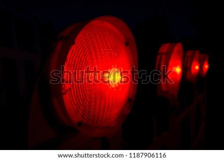 red construction work lights on black background