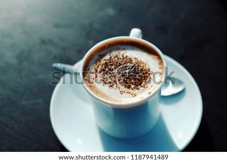 close up cup of hot chocolate on wood table, vintage tone