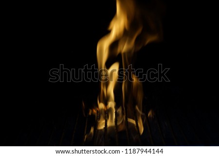 Flames in a barbecue. They have a yellow color. Front view, in outside and without character.