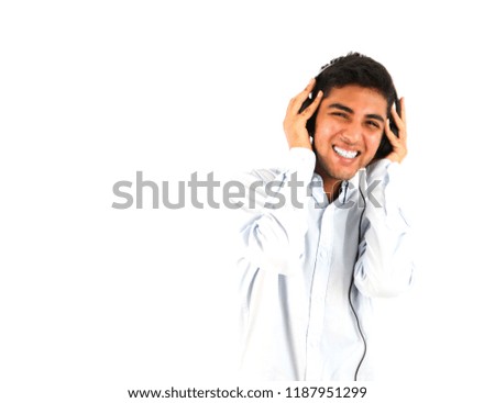 Happy young man wearing headphones against a white background