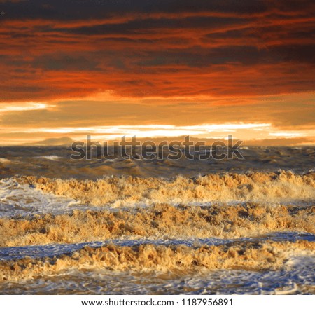 storm on sea under hot sunset clouds