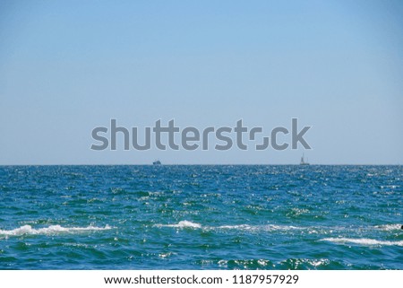 Photo of a sea landscape with a rocky beach. Picture taken in a clear sunny day