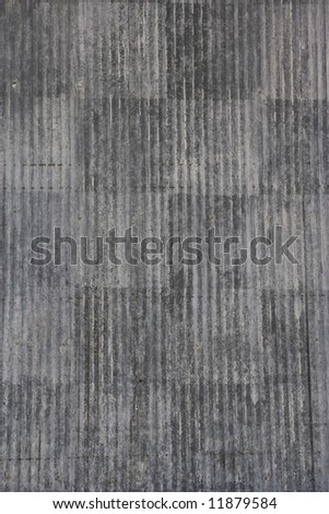 A weathered tin barn side. Faded panels of corrugated tin.