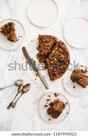 Homemade gluten free, vegetarian сarrot, banana and nuts Cake on white marble background