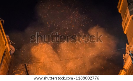 Smoke and ashes are flying in the night sky above the burning Falla Taut during la Crema final event during Las Fallas festival in Valencia Community in Spain.