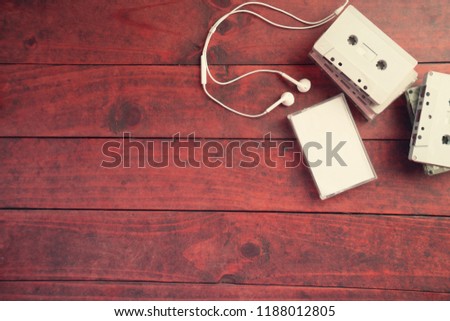 Top view of cassette tapes on wooden background.