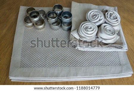 Golden napkin roses ring holders and place mats for decoration table events holiday and party wooden isolated background