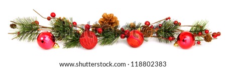 Long horizontal Christmas border with baubles, tree branches and berries over white
