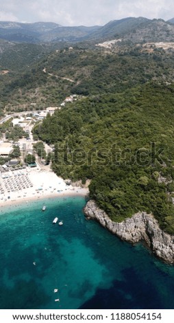 Aerial drone photo of popular mediterranean beach with turquoise clear waters and sun beds
