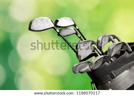 Different golf clubs on  background.