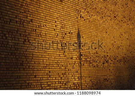 Brick wall with shadow of sign