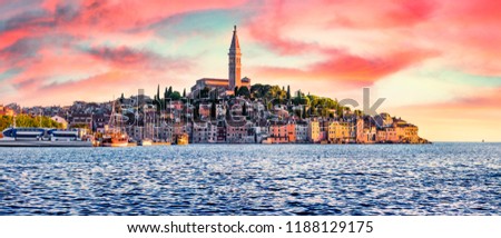 Fantastic spring sunset of Rovinj town, Croatian fishing port on the west coast of the Istrian peninsula. Impressive evening seascape of Adriatic Sea. Traveling concept background.