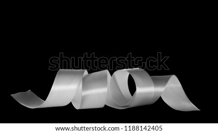 White ribbon isolated on black background and texture, with clipping path