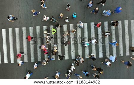 Pedestrian crosswalk with many people. Aerial view.