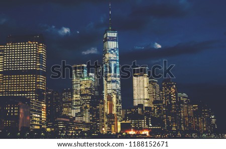 Scenery view of Lower Manhattan skyline at night with city lights in windows. Beautiful cityscape view of New York downtown. Contemporary metropolis city in need of a huge amount of electricity