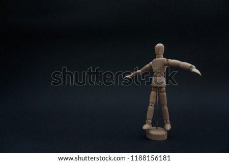 Close up of hand wooden dummy model on black background.