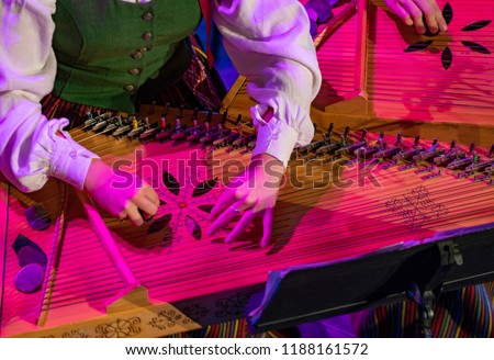 Hands playing on Kokle, a latvian plucked string instrument belonging to the Baltic box zither family Royalty-Free Stock Photo #1188161572