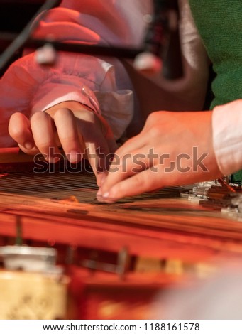 Hands playing on Kokle, a latvian plucked string instrument belonging to the Baltic box zither family Royalty-Free Stock Photo #1188161578