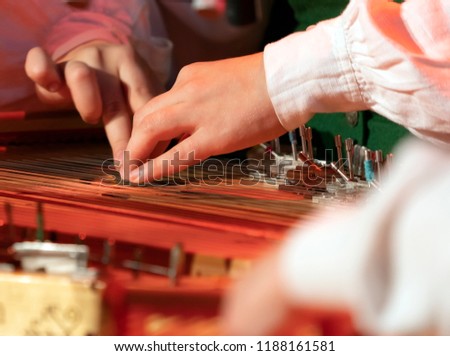 Hands playing on Kokle, a latvian plucked string instrument belonging to the Baltic box zither family Royalty-Free Stock Photo #1188161581